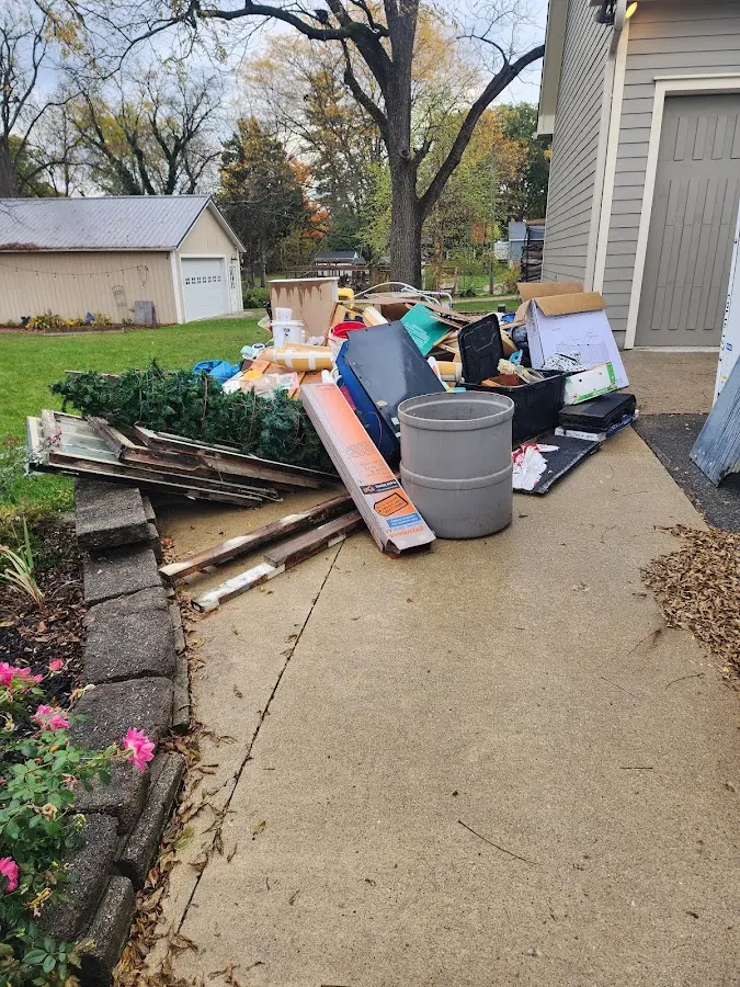 Dumpster being loaded with debris for 3 Yard Dumpster Rental in Belding